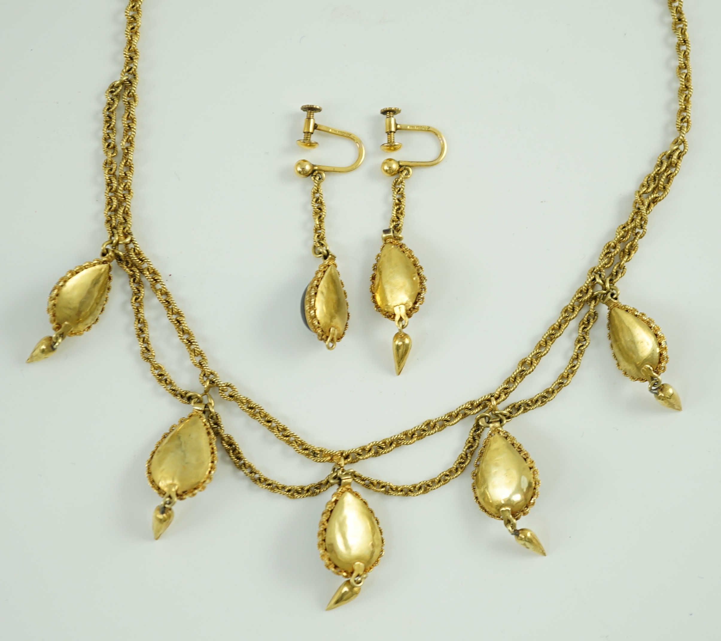 A 19th century Indian gold, garnet and seed pearl set demi parure, comprising and a drop fringe necklace and pair of matching ear clips